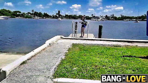 Busty redhead Annabel Redd in blue bikini on dock, outdoor tease