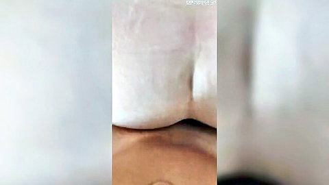 Pale big white ass up close with butt plug inserted deep in tight puckered anus doggy style.
