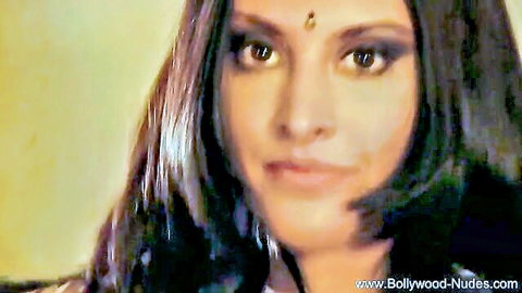 Exotic Indian dancer with bindi, seductive gaze in erotic pose