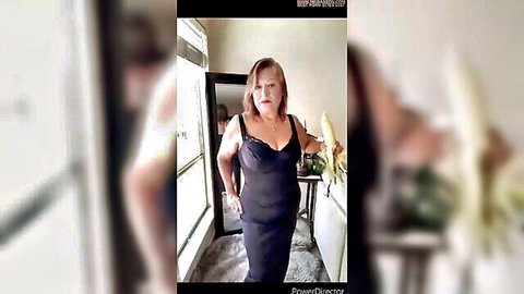 Mature blonde in black dress holding vegan organic dildo for hairy pussy play