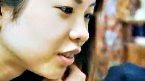 Close-up of sexy Japanese girl's parted lips teasing blowjob in POV