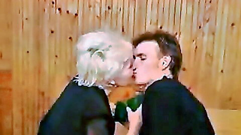 Curly-haired granny passionately kissing young man in old and young encounter