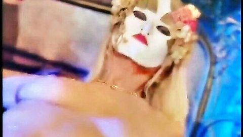 Blonde woman in floral mask exposing huge natural tits topless