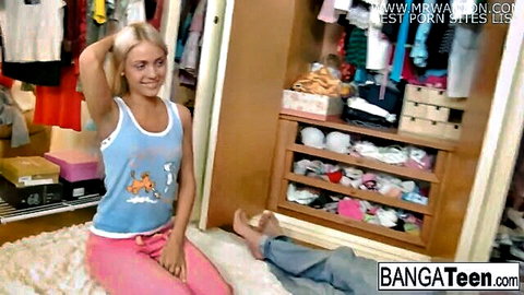 Pretty blonde teen in blue tank top and pink pants posing seductively with guy
