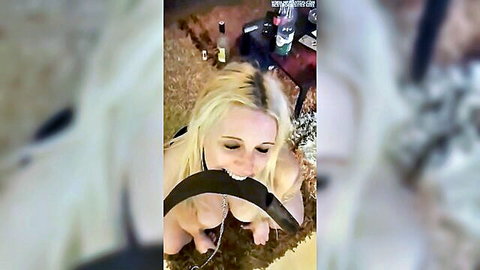 Blonde submissive woman gagged with strap and chained in BDSM scene