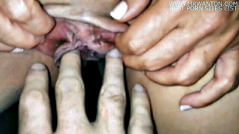 Close-up labia spreading revealing pink wet pussy