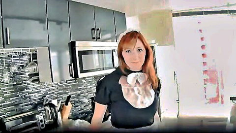 Redhead maid in sexy black uniform with white apron, smiling playfully