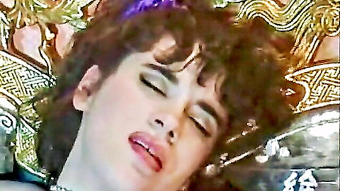 Brunette with curly hair and glossy lips in aroused close-up ecstasy face