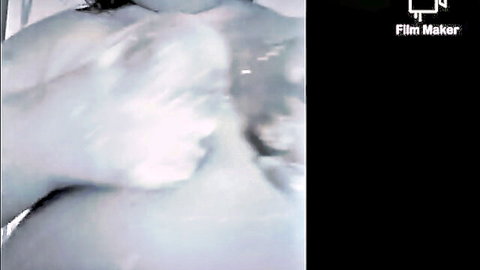Nude wet woman in steamy shower, side body close-up