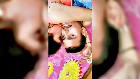 Intimate Indian couple embracing closely on bed, passionate moment