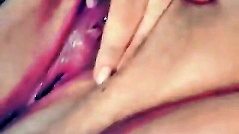 Closeup of fingers spreading wide open pink shaved pussy lips exposing wet inner vagina