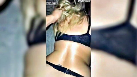 Blonde woman in black lace lingerie, teasing rear ass view