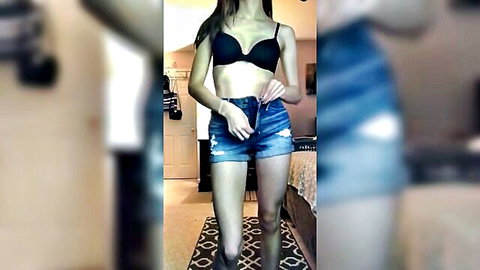 Slim brunette girlfriend stripping in black bra and denim shorts