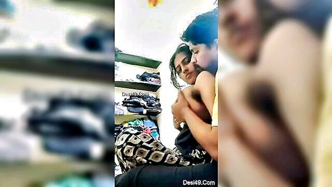 Desi couple in passionate embrace and kiss in clothing store