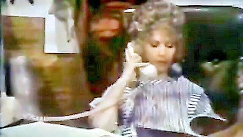 Vintage curly-haired woman in striped blouse talking on phone, cinema porn scene