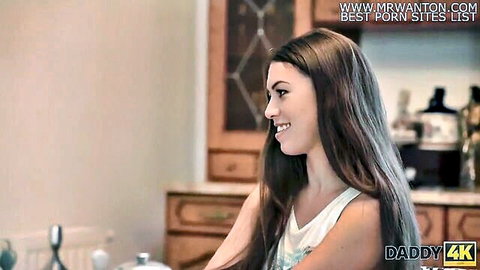 Petite brunette teen smiles seductively in white tank top in kitchen for Daddy4K old young fuck
