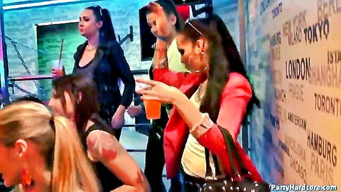 Hot party girls in tight club outfits holding drinks at wild graffiti wall rave
