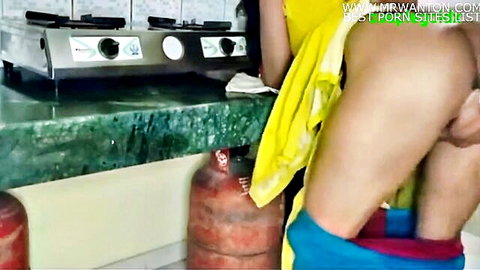 Indian couple fucking doggy style in kitchen as babe bends over counter with pants down exposing ass and pussy