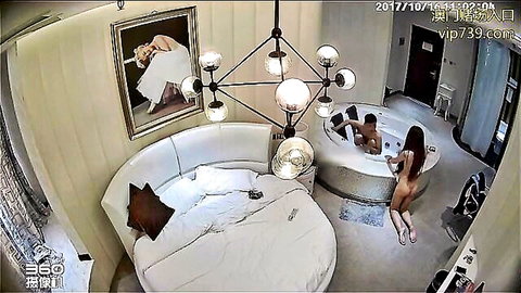 Two nude Asian women with a man in luxury hot tub threesome
