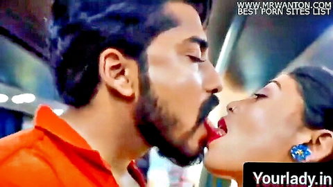 Passionate Indian couple kissing intensely on a moving bus