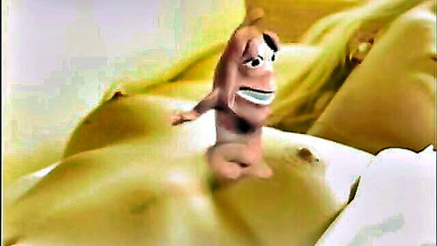 Humorous animated hot dog character between massive yellow breasts in funny adult video