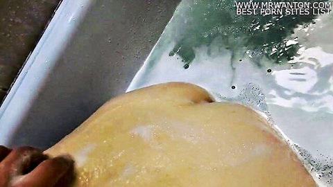 Hands spreading wet soapy big pale ass cheeks in bathtub exposing tight pussy