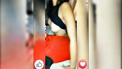 Blurry amateur thumbnail of Asian woman exposing breasts in black top and red bottoms