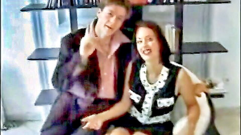 Monica Roccaforte smiling with male partner in sexy vest top