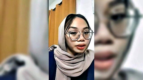 Cute Malay woman in hijab and glasses, soft teasing expression