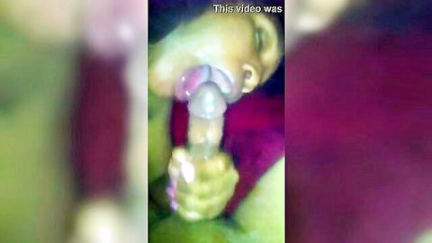 Blurry close-up of Indian woman giving blowjob to thick penis head