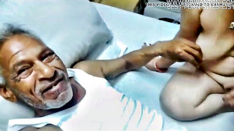 Young nude Indian woman grabs old black man's cock as he gropes her tight pussy on bed