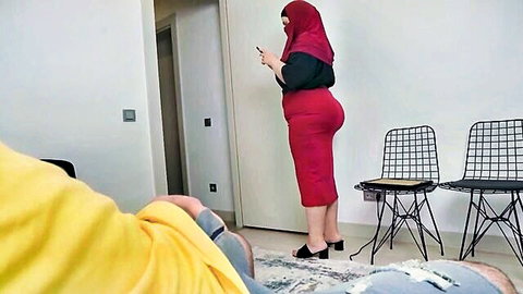 Hijabi MILF with huge ass in tight red pencil skirt stands teasingly viewed from low POV