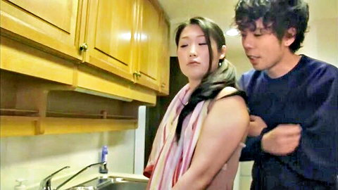 Japanese amateur wife with towel around neck touched on bare shoulders by man in kitchen