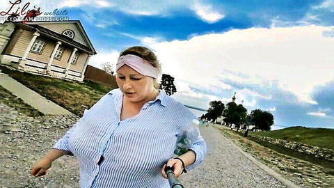 Lilydreamboobs walking outdoors in open blouse, massive natural tits
