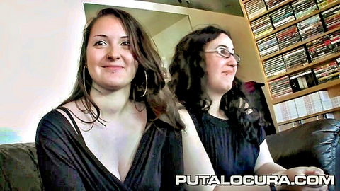 Busty lesbian couple smiling in revealing black tops
