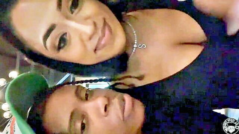 Two sexy ebony women selfie in club, one flashing deep cleavage and big tits