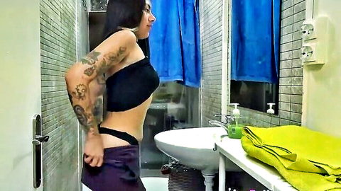 Tattooed Latina in black crop top and purple panties, teasing ass in bathroom