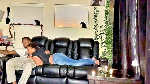 Ebony stepsister cuddles with stepbro on couch in tight jeans, movie night heats up