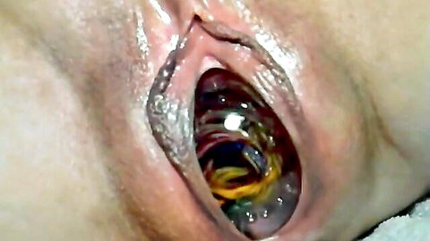 Close-up of wet vagina with inserted shiny ball toy