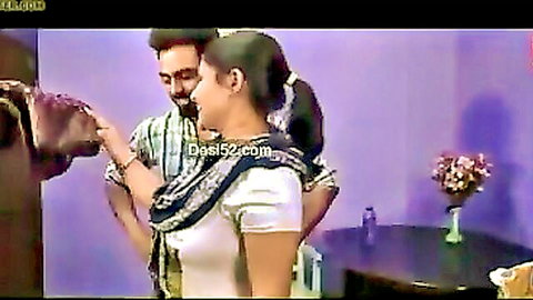 Mature Indian woman with big tits kissed on neck from behind by man in homemade scene