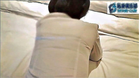 Asian woman in tight beige blouse kneeling on bed from behind ready for doggy fuck