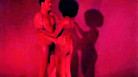 Remastered African couple nude embrace in red light, glamorous black bodies