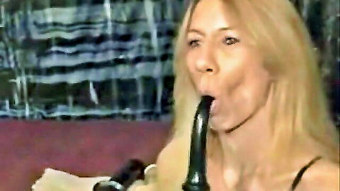 Blonde woman deepthroats large black dildo effortlessly, no gag reflex