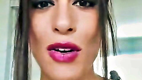 Sexy brunette puckering plump glossy purple lips seductively closeup