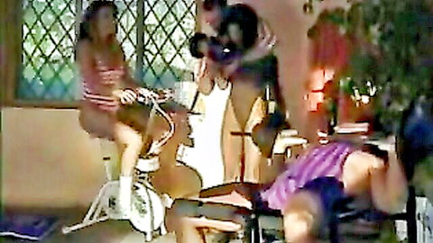 European women in bikinis with men in amateur group scene on bike
