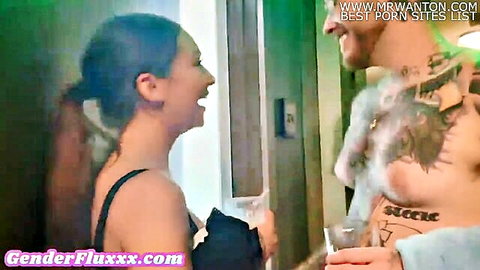 Brunette model girlfriend smiles at tattooed boyfriend in intimate chat
