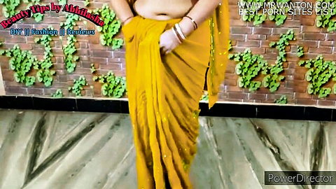 Indian mom in yellow saree exposing midriff, teasing solo