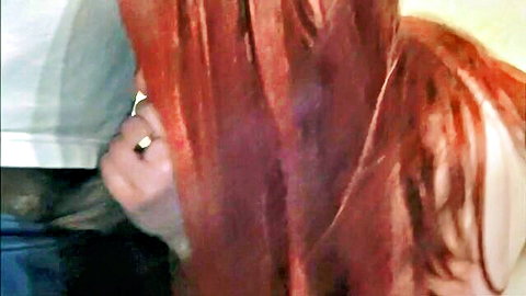 Redhead with hand on white top, teasing post-blowjob cum play scene