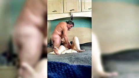 Nude mature granny and older man in intimate bedroom spooning pose