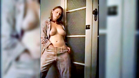 Ally A. Brey teasing in open coat exposing breasts at doorway
